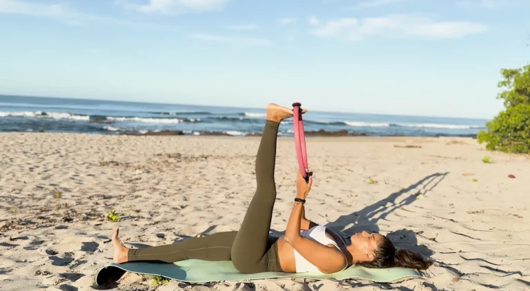 women on beach unlocking tight hamstrings